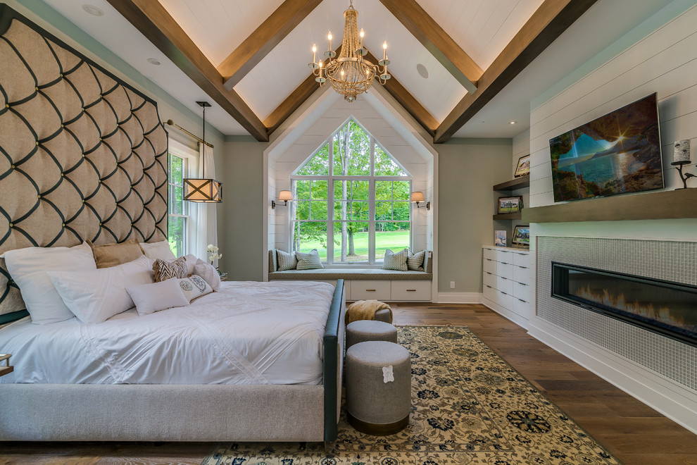 Inspiration for a large country master bedroom in Cleveland with grey walls, dark hardwood floors, a ribbon fireplace, a tile fireplace surround and brown floor.