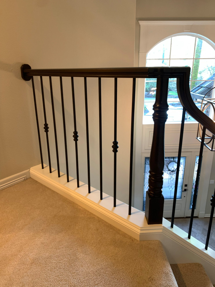 Photo of a mid-sized transitional carpeted curved staircase in Portland with carpet risers and wood railing.