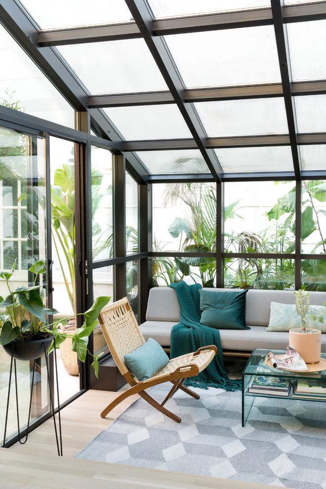 Photo of a small contemporary sunroom in San Francisco with light hardwood floors, a glass ceiling and beige floor.