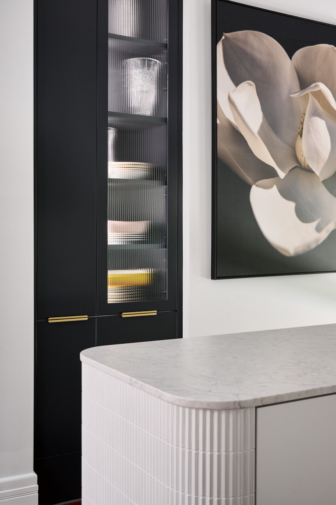 Large minimalist galley dark wood floor and brown floor kitchen photo in Perth with an undermount sink, flat-panel cabinets, white cabinets, quartz countertops, white backsplash, quartz backsplash, black appliances, an island and white countertops
