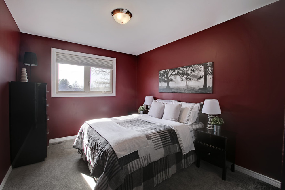 Photo of a mid-sized contemporary guest bedroom in Toronto with red walls, carpet, no fireplace and grey floor.