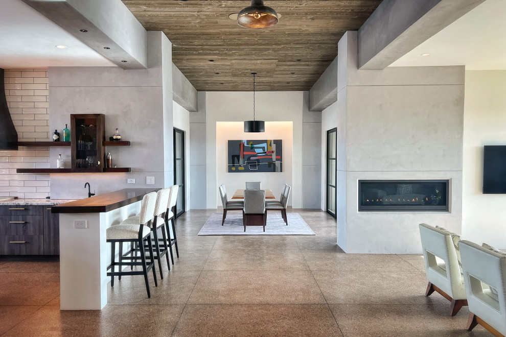 Large minimalist open concept concrete floor, brown floor and wood ceiling living room photo in Albuquerque with a bar, gray walls, a ribbon fireplace, a metal fireplace and a wall-mounted tv