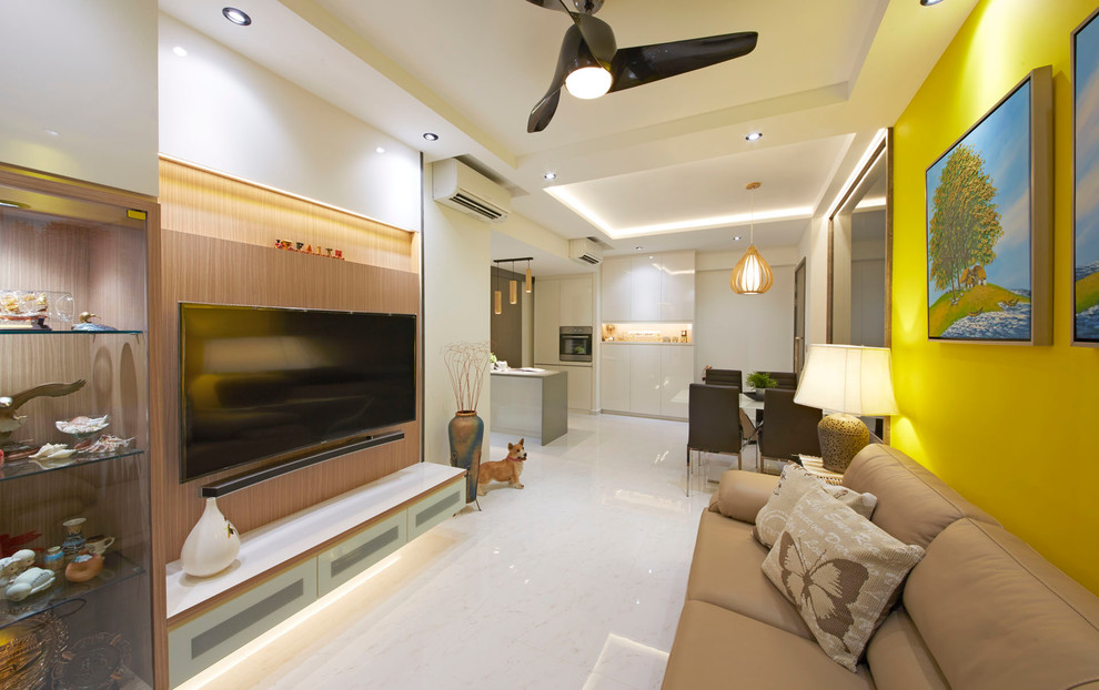 Small modern formal open concept living room in Singapore with a wall-mounted tv, yellow walls and porcelain floors.