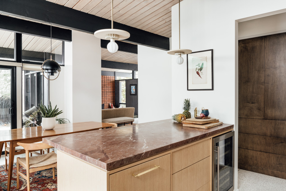 Inspiration for a medium sized retro l-shaped kitchen/diner in Salt Lake City with an integrated sink, flat-panel cabinets, light wood cabinets, marble worktops, red splashback, glass tiled splashback, white appliances, terrazzo flooring, a breakfast bar, grey floors, red worktops and exposed beams.