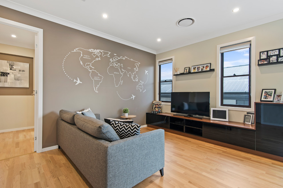 Photo of a mid-sized contemporary open concept family room in Brisbane with brown walls, a wall-mounted tv and light hardwood floors.