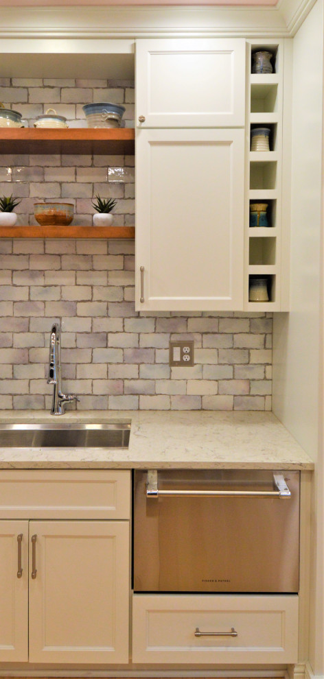 Kitchen - small transitional light wood floor kitchen idea in Milwaukee with a single-bowl sink, shaker cabinets, white cabinets, quartzite countertops, ceramic backsplash and stainless steel appliances