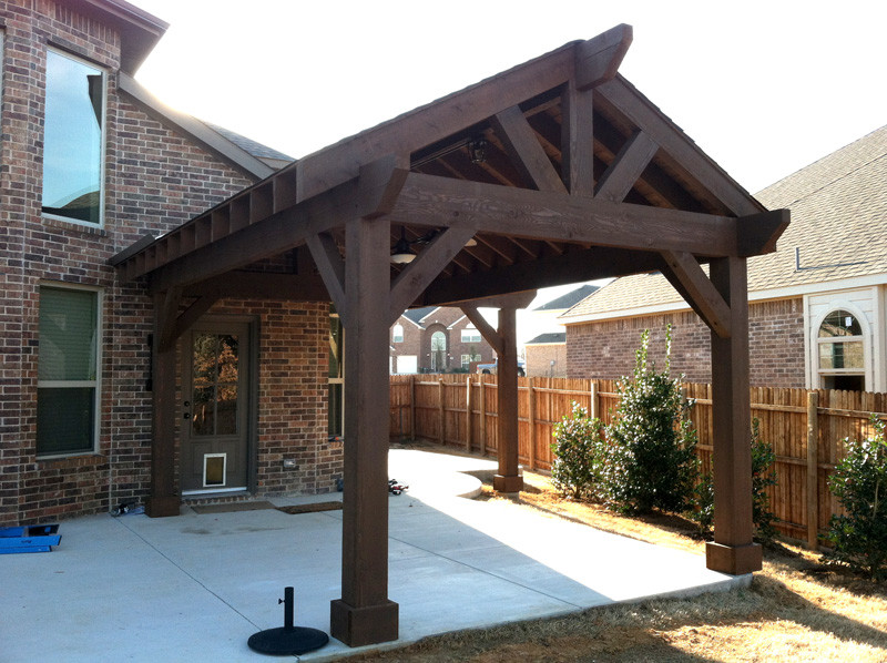 This is an example of a mid-sized country backyard patio in Dallas with concrete slab and a gazebo/cabana.