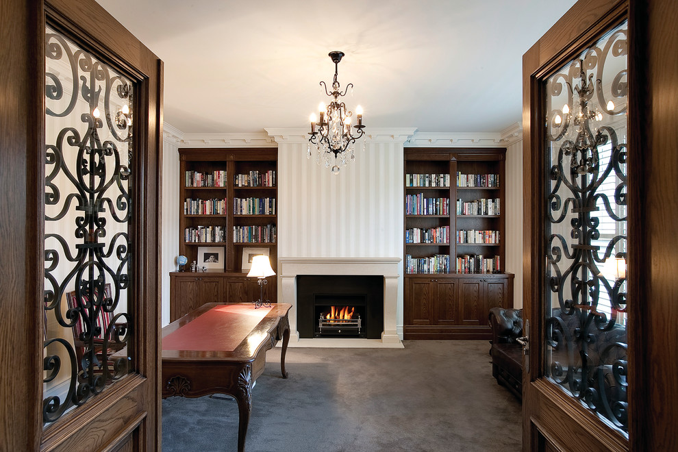 Photo of a mid-sized traditional study room in Melbourne with a standard fireplace, a freestanding desk and white walls.