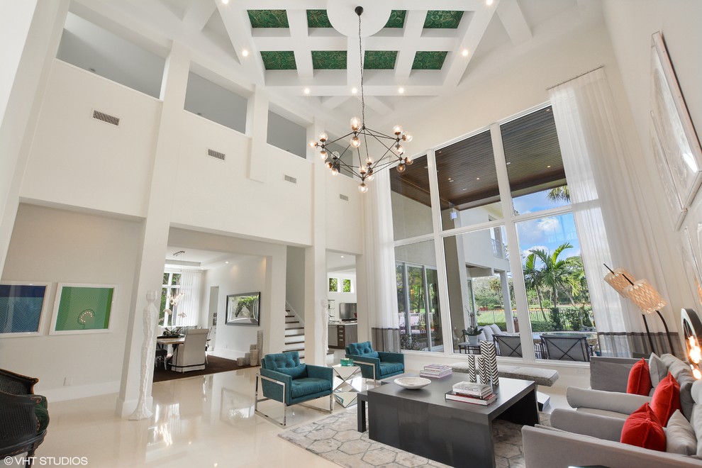 Large contemporary formal open concept living room in Miami with white walls and porcelain floors.