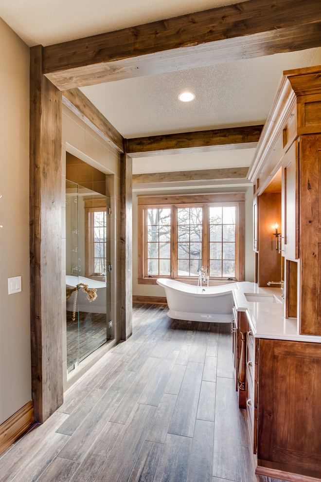 Freestanding bathtub - large rustic master multicolored tile and ceramic tile ceramic tile freestanding bathtub idea with an undermount sink, recessed-panel cabinets, medium tone wood cabinets, quartzite countertops, a two-piece toilet and beige walls