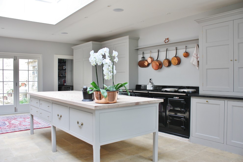 Design ideas for a mid-sized traditional single-wall kitchen in Gloucestershire with recessed-panel cabinets, grey cabinets, with island and yellow floor.