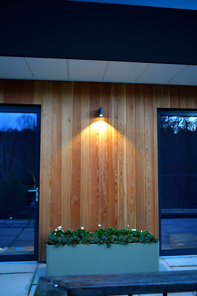 Contemporary house exterior in Devon with wood cladding.