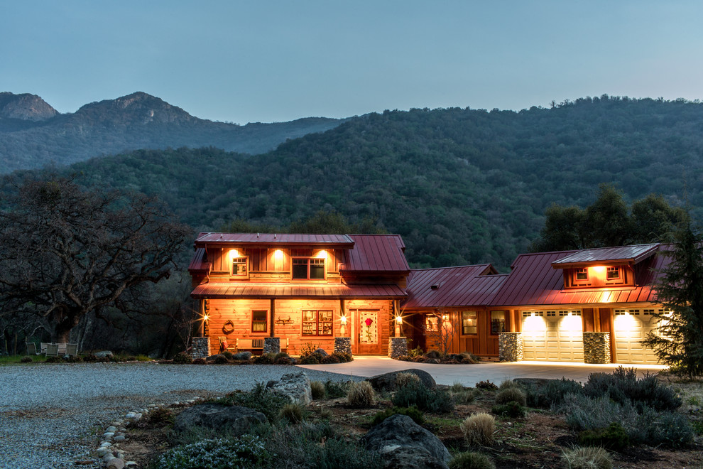Huge mountain style brown two-story wood exterior home photo in Boston with a clipped gable roof