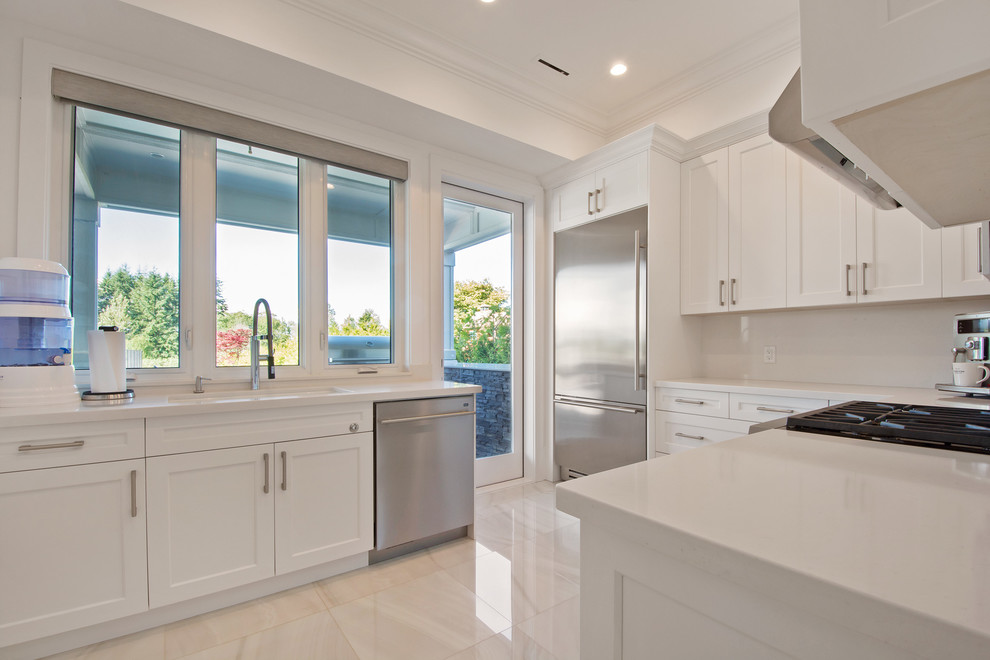 Photo of a large traditional separate kitchen in Vancouver with a drop-in sink, flat-panel cabinets, white cabinets, quartzite benchtops, white splashback, panelled appliances and marble floors.