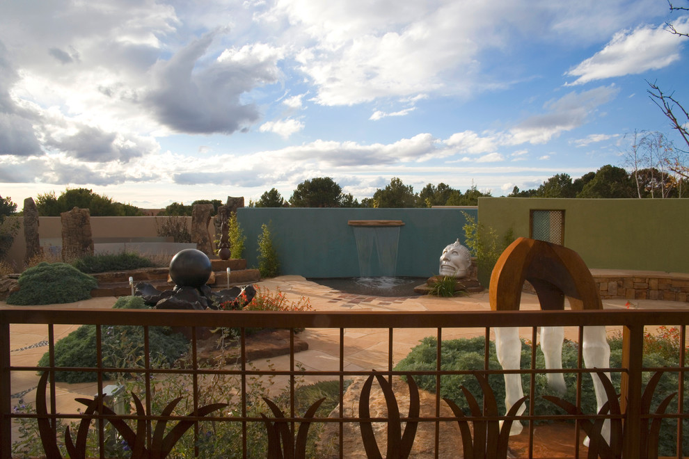 Contemporary backyard patio in Albuquerque with a water feature.