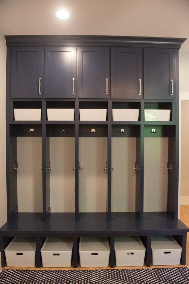 Example of a large transitional u-shaped home design design with shaker cabinets, blue cabinets, a side-by-side washer/dryer and white countertops