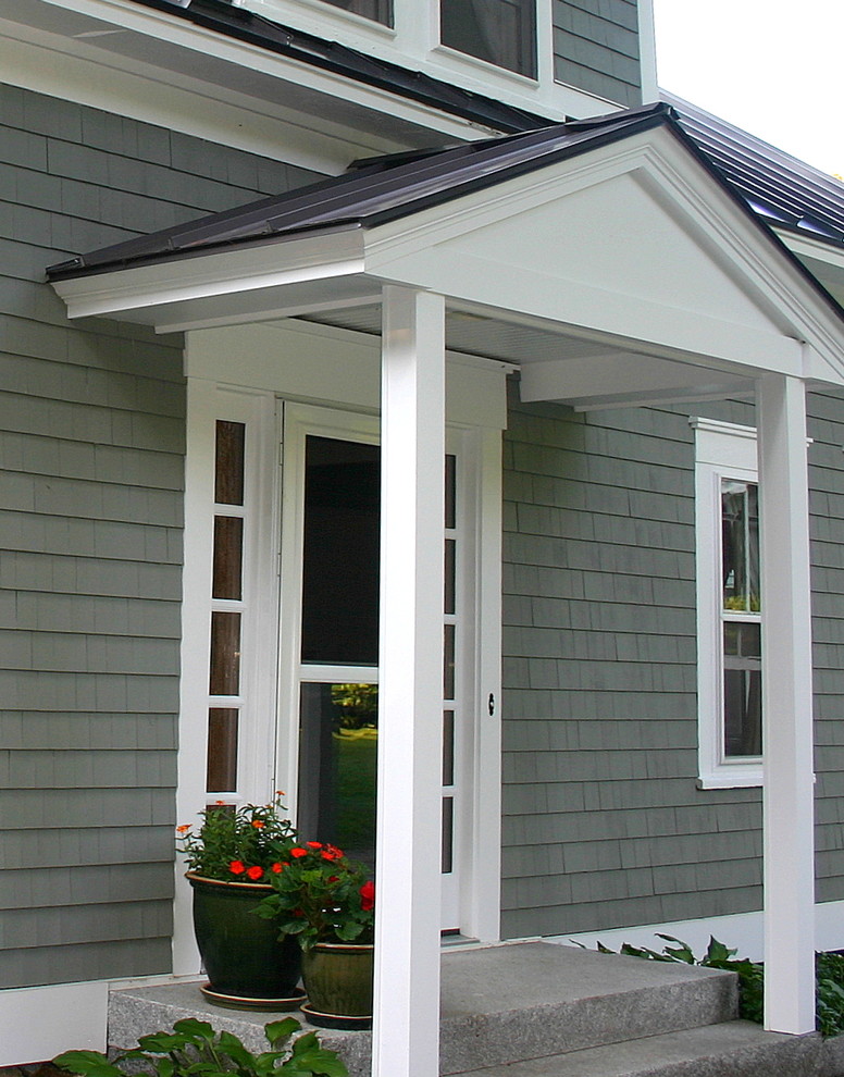 This is an example of a country two-storey grey house exterior in Boston with a metal roof.
