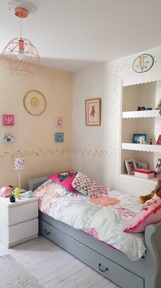 Photo of a small traditional kids' bedroom for kids 4-10 years old and girls in Other with blue walls, painted wood floors and white floor.