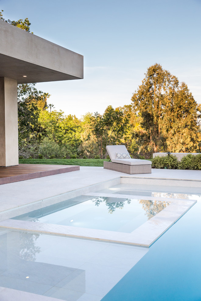 This is an example of a contemporary backyard rectangular pool in Orange County.