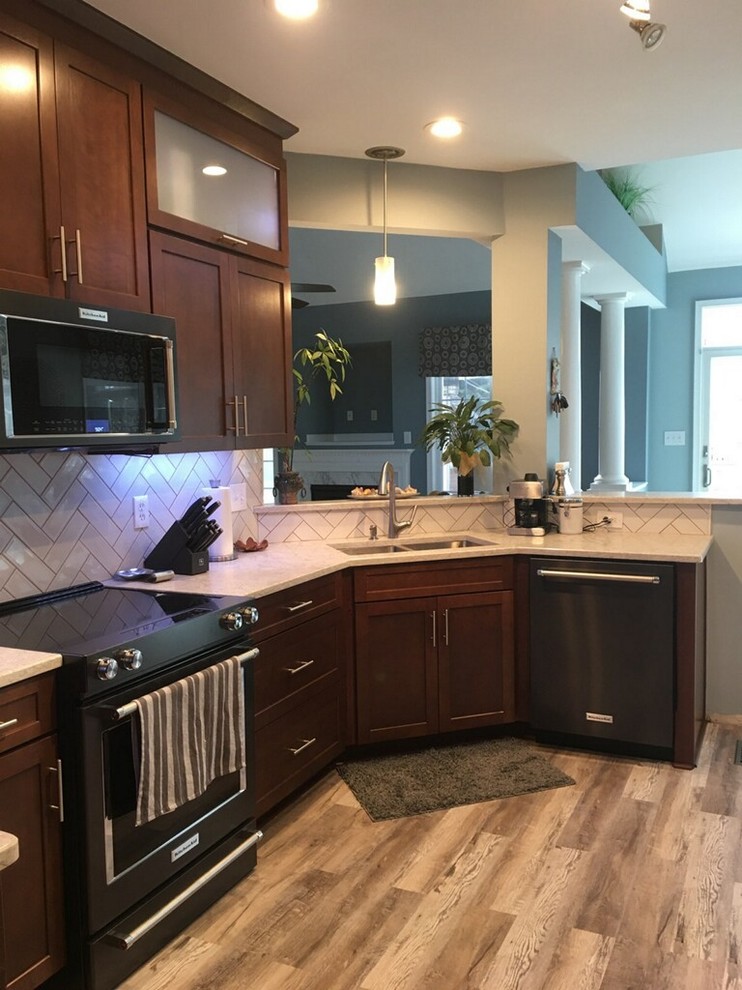 Inspiration for a mid-sized transitional u-shaped vinyl floor and gray floor open concept kitchen remodel in Richmond with a single-bowl sink, shaker cabinets, dark wood cabinets, quartz countertops, white backsplash, ceramic backsplash, black appliances and white countertops