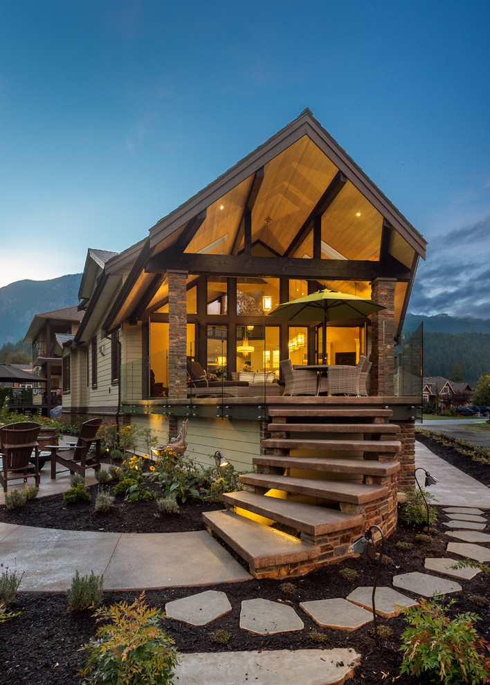 Inspiration for a large country backyard deck in Vancouver with an outdoor kitchen and a roof extension.