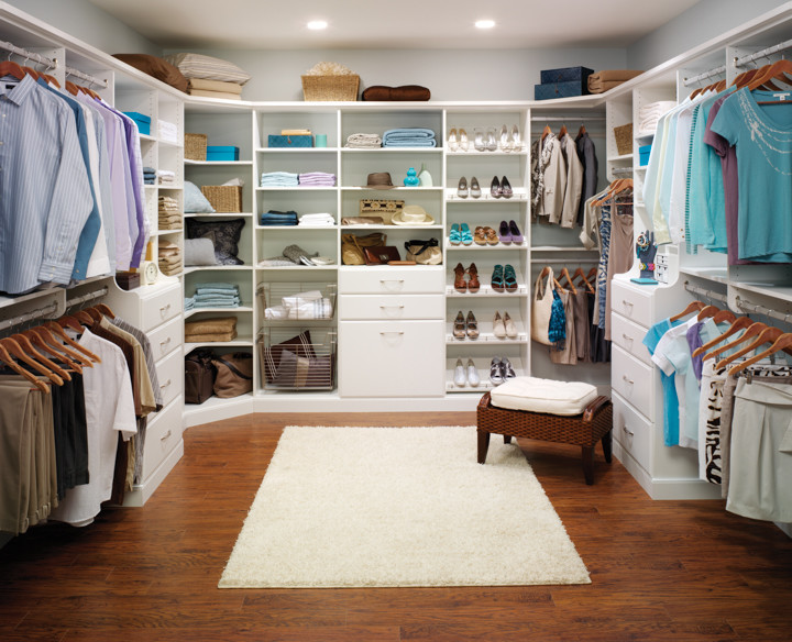 Design ideas for a large transitional gender-neutral walk-in wardrobe in Other with open cabinets, white cabinets, medium hardwood floors and brown floor.