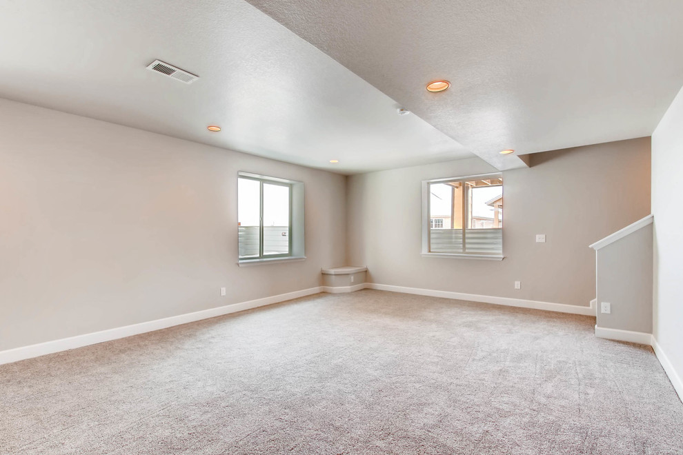 Basement - large underground carpeted and gray floor basement idea in Denver with gray walls and no fireplace