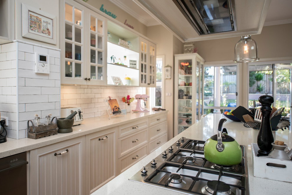 Inspiration for a large traditional l-shaped eat-in kitchen in Sydney with a farmhouse sink, recessed-panel cabinets, white cabinets, quartz benchtops, white splashback, porcelain splashback, stainless steel appliances, light hardwood floors, with island and white benchtop.