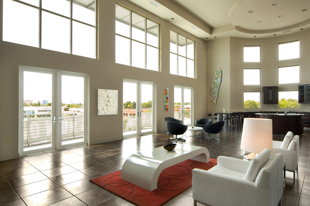 Inspiration for an expansive modern formal loft-style living room in Las Vegas with beige walls, porcelain floors, a corner fireplace, a stone fireplace surround and a concealed tv.