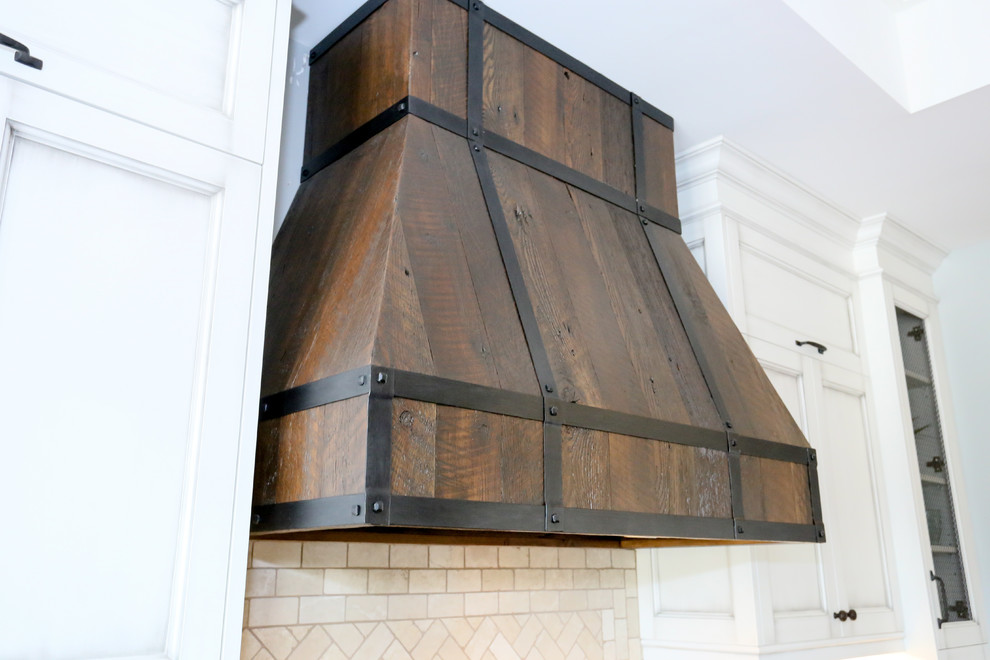Inspiration for a large rustic l-shaped dark wood floor and brown floor open concept kitchen remodel in Toronto with an undermount sink, recessed-panel cabinets, white cabinets, beige backsplash, glass tile backsplash, stainless steel appliances, an island, onyx countertops and black countertops
