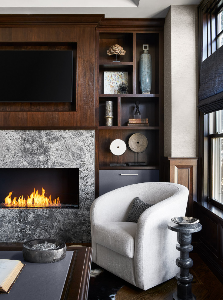 Large transitional study room in Chicago with grey walls, dark hardwood floors, a ribbon fireplace, a stone fireplace surround, a freestanding desk, brown floor, vaulted and panelled walls.