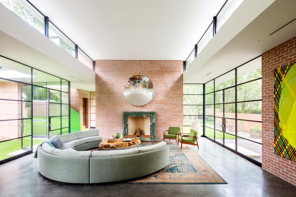 Midcentury open concept living room in Houston with red walls, concrete floors, a standard fireplace and grey floor.