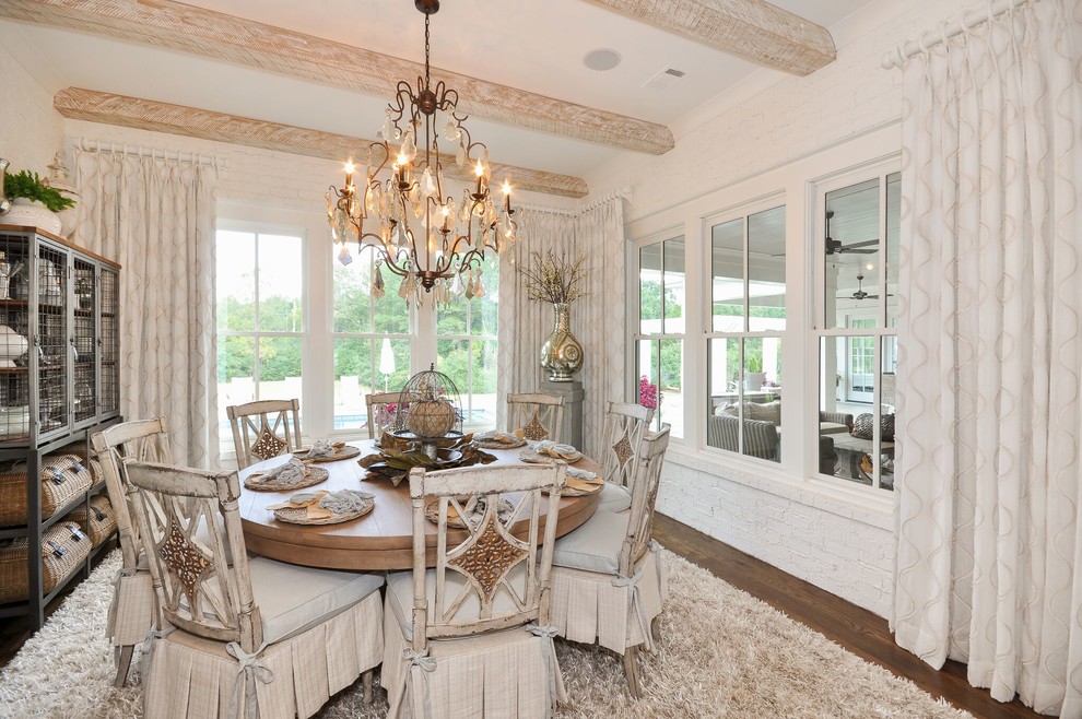 This is an example of a large country dining room in Atlanta with white walls, dark hardwood floors and no fireplace.