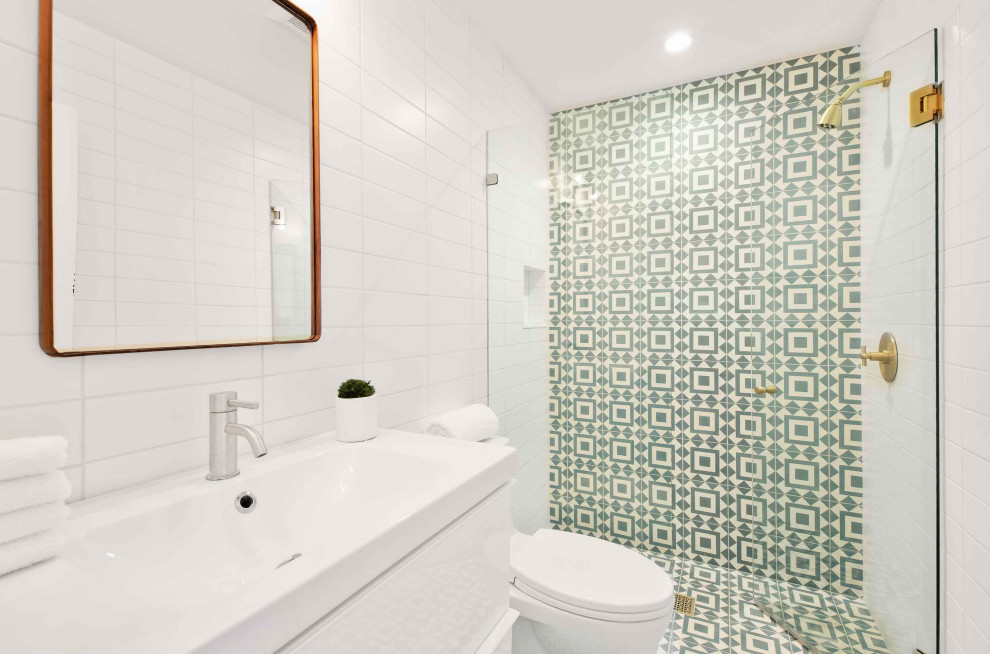 Mid-sized contemporary 3/4 bathroom in Los Angeles with flat-panel cabinets, white cabinets, a one-piece toilet, white tile, ceramic tile, white walls, an integrated sink, a hinged shower door, white benchtops, a curbless shower, cement tiles, green floor, a niche, a single vanity and a built-in vanity.