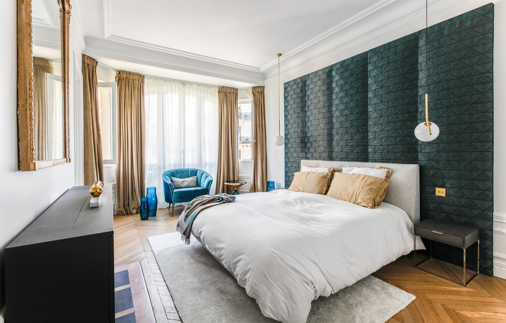 This is an example of a transitional bedroom in Paris with white walls, medium hardwood floors and brown floor.