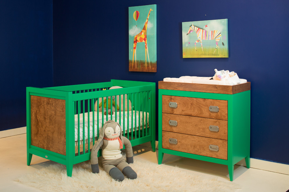 This is an example of a small contemporary gender-neutral nursery in Orange County with blue walls and carpet.