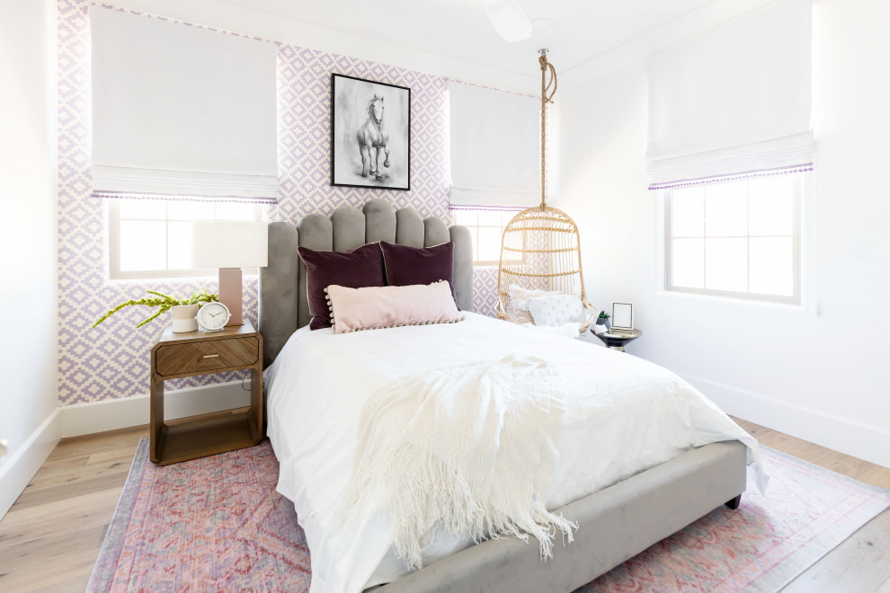Contemporary bedroom in Phoenix with purple walls, medium hardwood floors, brown floor and wallpaper.
