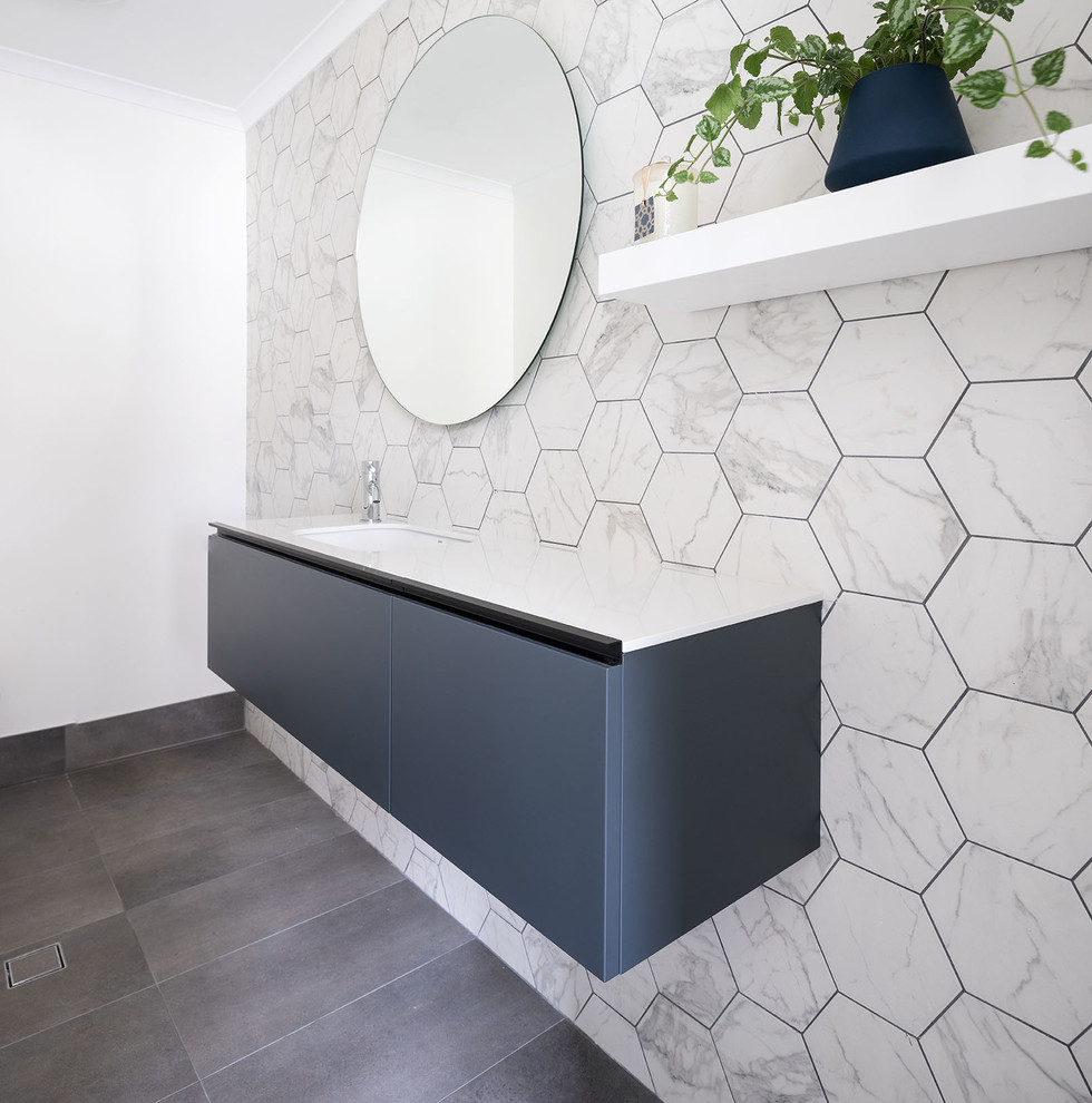 Contemporary bathroom in Perth with solid surface benchtops.