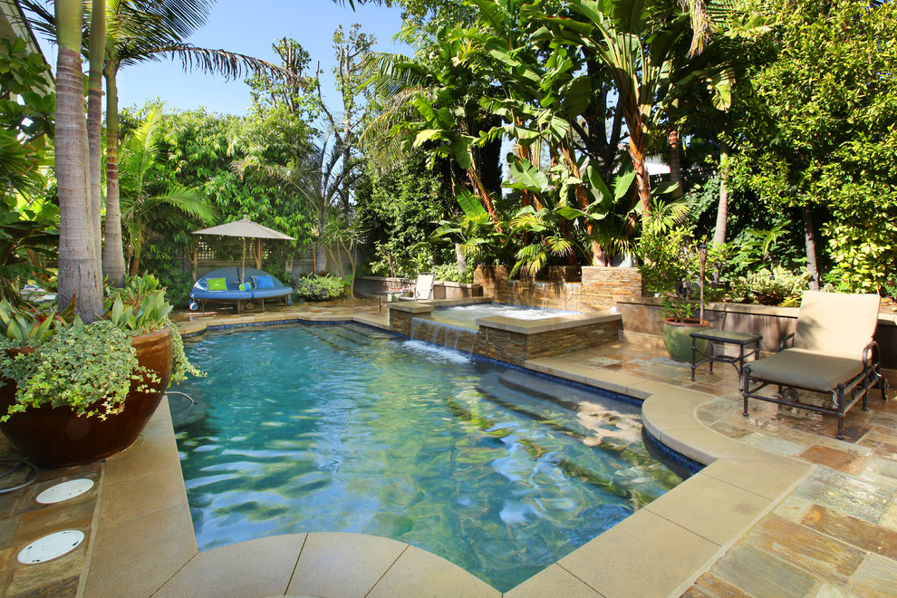 Photo of a tropical custom-shaped pool in Orange County.