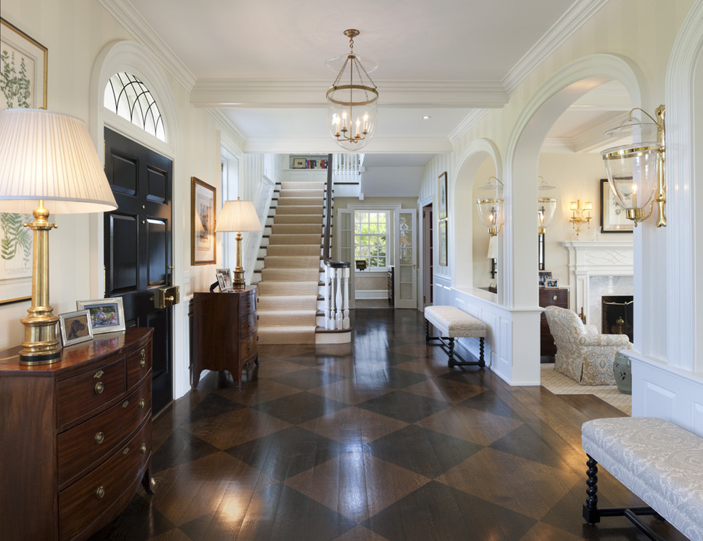 This is an example of a large traditional foyer in Philadelphia with dark hardwood floors, a single front door, a black front door and brown floor.