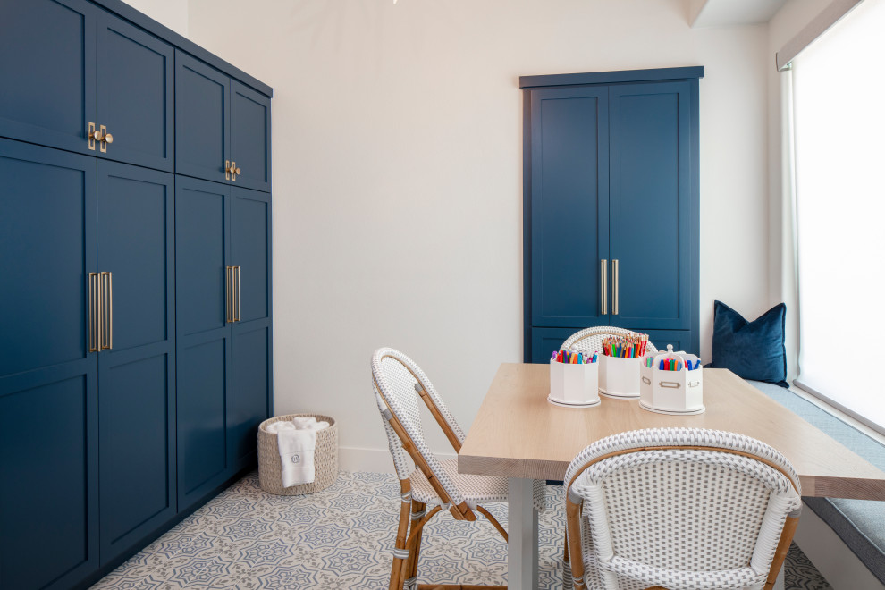 Mid-sized transitional gender-neutral kids' playroom in Austin with white walls, ceramic floors and blue floor for kids 4-10 years old.