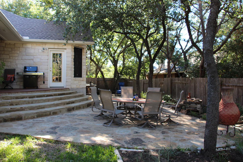 Inspiration for a medium sized traditional back patio in Austin with natural stone paving and no cover.