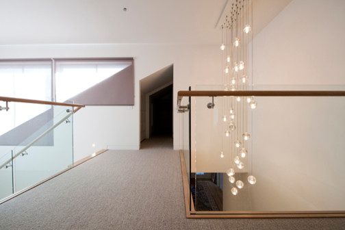 Inspiration for a large contemporary wood u-shaped staircase in Melbourne with wood risers.