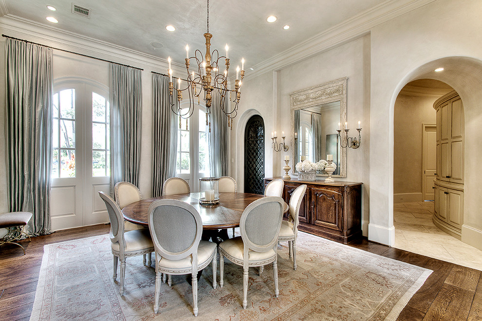 Photo of a traditional dining room in Houston with white walls and dark hardwood floors.