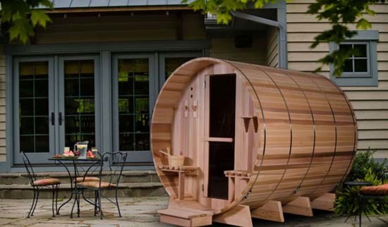 Large backyard deck photo in Boston with a fire pit and an awning
