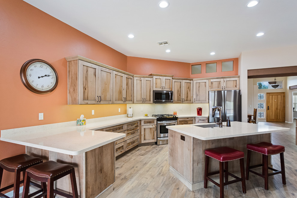 Open concept kitchen - large transitional u-shaped porcelain tile and gray floor open concept kitchen idea in Phoenix with an undermount sink, flat-panel cabinets, beige cabinets, wood countertops, stainless steel appliances, an island and beige countertops