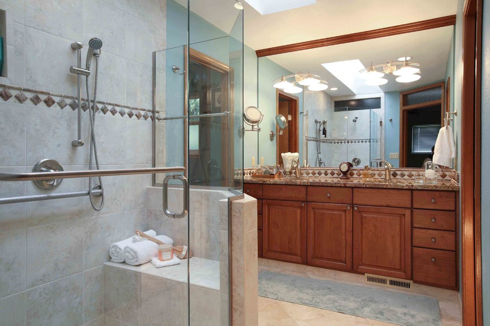 Inspiration for a mid-sized transitional master brown tile and ceramic tile porcelain tile freestanding bathtub remodel in Seattle with recessed-panel cabinets, a two-piece toilet, a vessel sink, medium tone wood cabinets, granite countertops and gray walls