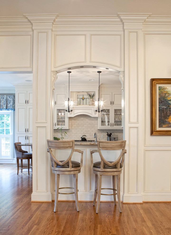 Design ideas for a traditional kitchen in Charlotte with white cabinets and white splashback.