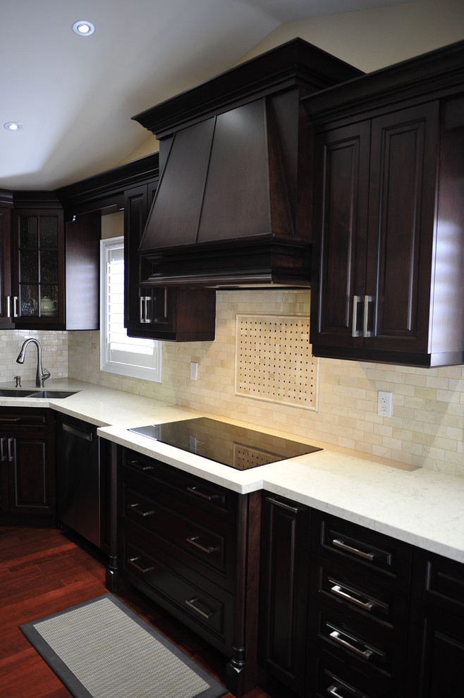 Eat-in kitchen - mid-sized transitional u-shaped eat-in kitchen idea in Toronto with a double-bowl sink, raised-panel cabinets, dark wood cabinets, quartz countertops, multicolored backsplash, matchstick tile backsplash, stainless steel appliances and a peninsula