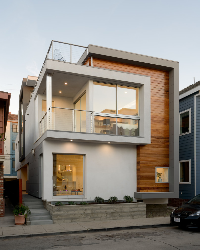 Design ideas for a contemporary two-storey exterior in Los Angeles with mixed siding.